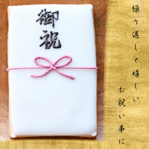 蝶結び熨斗袋『御祝』のアイシングクッキー写真。金の背景の上に黒文字で『繰り返して嬉しいお祝い事に』と記載あり。